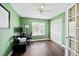 Bright green office with computer desk, wood floors, a ceiling fan and closet at 2209 Lupine Pl, Erie, CO 80516