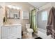 Bright bathroom features tiled shower and updated vanity at 3102 N Columbine St, Denver, CO 80205