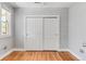 Bedroom with hardwood floors and sliding closet doors at 3102 N Columbine St, Denver, CO 80205