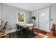 Bright dining area features a large window, stylish rug, and door to the outside at 3102 N Columbine St, Denver, CO 80205