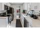 Bright, renovated kitchen with white cabinets, stainless steel appliances, and modern finishes at 3102 N Columbine St, Denver, CO 80205