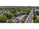 Aerial view showcasing apartment building with parking, mature trees and green landscape at 12120 Melody Dr # 308, Westminster, CO 80234