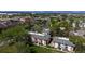 Aerial view of apartment buildings with mature trees and grassy areas against mountain backdrop at 12120 Melody Dr # 308, Westminster, CO 80234