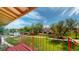 Scenic balcony view overlooking lush greenery, a tranquil pond, and nearby residential buildings at 12120 Melody Dr # 308, Westminster, CO 80234