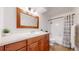 Bathroom with a wooden vanity, a wide mirror and a shower with curtain at 12120 Melody Dr # 308, Westminster, CO 80234