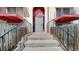 Building entrance featuring steps leading to the main door and metal railings, and a red color scheme at 12120 Melody Dr # 308, Westminster, CO 80234