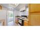 Functional kitchen with basic appliances, wood cabinetry, and access to the living area at 12120 Melody Dr # 308, Westminster, CO 80234