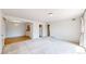 Spacious living room featuring carpet, a sliding door and access to kitchen and hall at 12120 Melody Dr # 308, Westminster, CO 80234