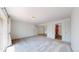 Spacious, neutral living room with carpeted floors, a balcony, and open access to other rooms at 12120 Melody Dr # 308, Westminster, CO 80234