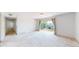 Bright and airy living room with neutral carpet and sliding glass door leading to a balcony at 12120 Melody Dr # 308, Westminster, CO 80234