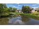 Picturesque pond surrounded by green foliage and multi-story buildings, offering a tranquil neighborhood ambiance at 12120 Melody Dr # 308, Westminster, CO 80234