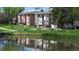 Scenic pond view with reflections of residential buildings, complemented by lush green landscape at 12120 Melody Dr # 308, Westminster, CO 80234
