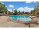 Sparkling community pool surrounded by green landscaping with lounge chairs and lifeguard stand at 12120 Melody Dr # 308, Westminster, CO 80234