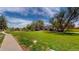 A serene, park-like setting with lush green lawn and mature trees surrounds this home at 12120 Melody Dr # 308, Westminster, CO 80234