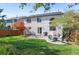 Large backyard showcases a patio with seating, a grill, and lush green grass at 8864 S Field Ct, Littleton, CO 80128