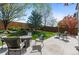 Relaxing backyard featuring a patio with outdoor seating and a well-maintained lawn at 8864 S Field Ct, Littleton, CO 80128