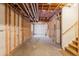 Unfinished basement ready for customization, featuring exposed framing and ample space at 8864 S Field Ct, Littleton, CO 80128