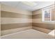 Finished basement with a neutral color palette and a window providing natural light at 8864 S Field Ct, Littleton, CO 80128