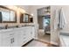 Bathroom with double sinks and a view into the main bedroom at 8864 S Field Ct, Littleton, CO 80128