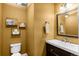 Stylish half-bathroom features a decorative mirror, toilet, and fixtures at 8864 S Field Ct, Littleton, CO 80128