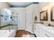 Bright and modern bathroom features a shower, tub, and double sink at 8864 S Field Ct, Littleton, CO 80128