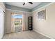 Bedroom boasts neutral walls, plush carpet, and a sunny window overlooking scenic views at 8864 S Field Ct, Littleton, CO 80128