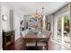 Chic dining room featuring hardwood floors, designer lighting, and access to outdoor patio at 8864 S Field Ct, Littleton, CO 80128