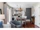 Elegant dining area adjacent to kitchen with hardwood floors and a modern chandelier at 8864 S Field Ct, Littleton, CO 80128