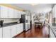 Open kitchen with stainless steel fridge that flows to a dining area and living room at 8864 S Field Ct, Littleton, CO 80128
