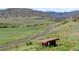 Picturesque landscape featuring a valley with green pastures, rolling hills, and a winding road at 8864 S Field Ct, Littleton, CO 80128