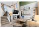 Cozy living room with fireplace, high ceilings, and integrated entertainment center at 8864 S Field Ct, Littleton, CO 80128