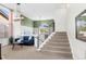 Bright living room featuring high ceilings, modern staircase, and stylish decor at 8864 S Field Ct, Littleton, CO 80128