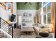 Bright living room featuring high ceilings, large windows, and comfortable seating at 8864 S Field Ct, Littleton, CO 80128