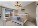 Spacious main bedroom with a ceiling fan and large windows showcasing the outdoor landscape at 8864 S Field Ct, Littleton, CO 80128