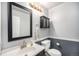 Small bathroom with dark vanity, white sink, and toilet at 2575 S Independence Ct, Lakewood, CO 80227