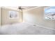 Spacious carpeted bedroom with two windows and ceiling fan at 2575 S Independence Ct, Lakewood, CO 80227