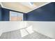 Bedroom with blue walls, white trim, and tiled floors at 2575 S Independence Ct, Lakewood, CO 80227