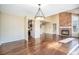 Open concept dining area with hardwood floors and a brick fireplace at 2575 S Independence Ct, Lakewood, CO 80227