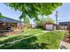 Large backyard featuring a shed, brick patio, grill, and seating at 2564 S Acoma St, Denver, CO 80223