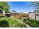 Private backyard featuring a cozy fire pit area with chairs and a relaxing hot tub at 2564 S Acoma St, Denver, CO 80223