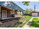 Backyard with patio, grill, flower planters, and a shed at 2564 S Acoma St, Denver, CO 80223
