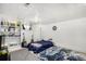 Basement bedroom with a comfortable bed, rug, and shelving at 2564 S Acoma St, Denver, CO 80223