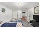 Finished basement bedroom area with comfortable bed, beanbag chair, and closet at 2564 S Acoma St, Denver, CO 80223