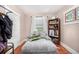 Cozy bedroom with hardwood floors and built-in shelving at 2564 S Acoma St, Denver, CO 80223