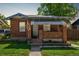 Charming brick home with a covered front porch and well-maintained lawn at 2564 S Acoma St, Denver, CO 80223
