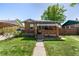 Charming brick home featuring a covered front porch and well-maintained lawn at 2564 S Acoma St, Denver, CO 80223
