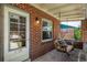 Inviting front porch with a swing, brick accents, and cozy ambiance at 2564 S Acoma St, Denver, CO 80223
