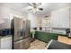 Kitchen with stainless steel appliances and green cabinets at 2564 S Acoma St, Denver, CO 80223
