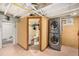 Basement laundry room with stacked washer and dryer adjacent to bathroom at 2564 S Acoma St, Denver, CO 80223