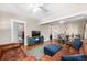 Open-concept living room with hardwood floors, dining area, and neutral decor at 2564 S Acoma St, Denver, CO 80223